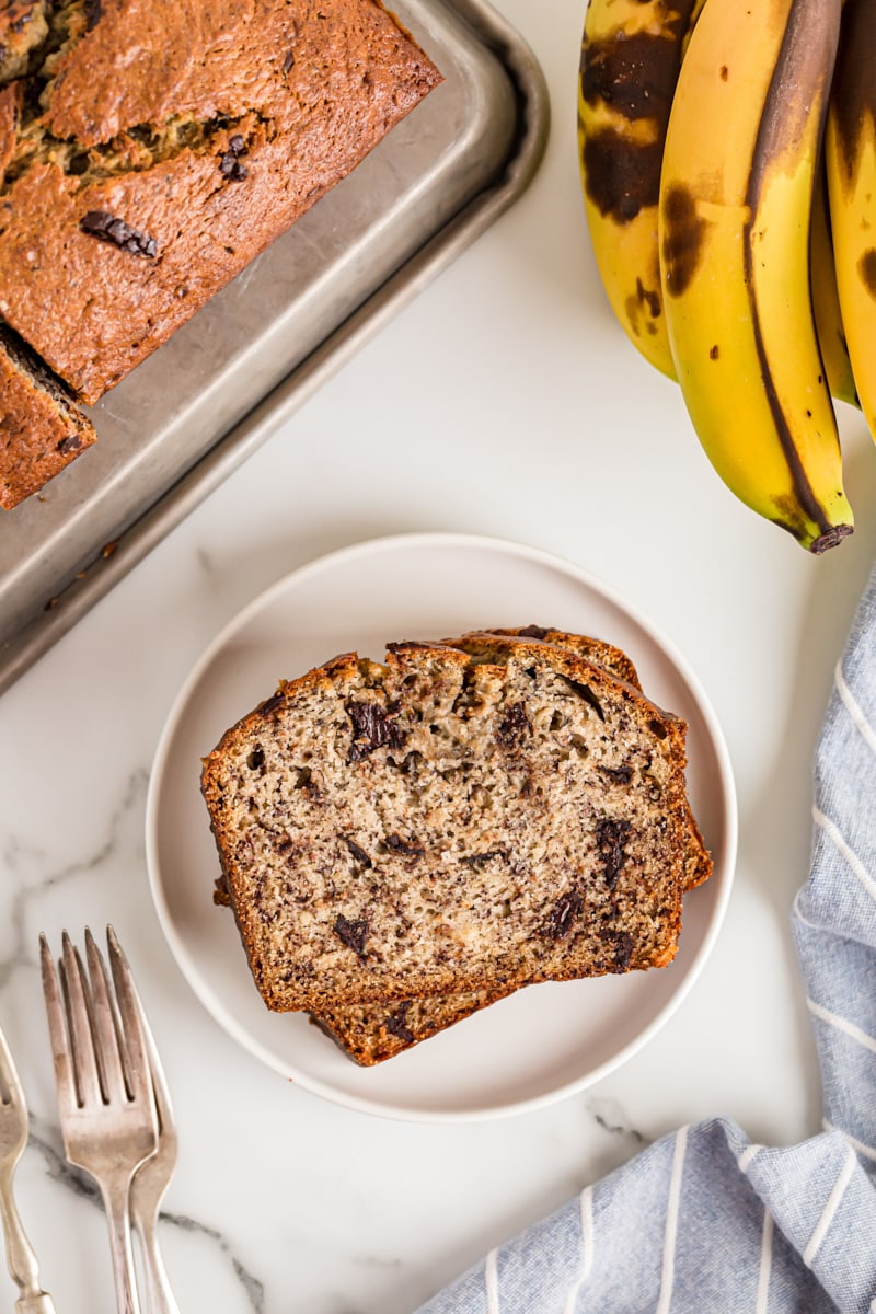 Overhead view of two slices of Chocolate Chunk Banana Bread stacked on plate