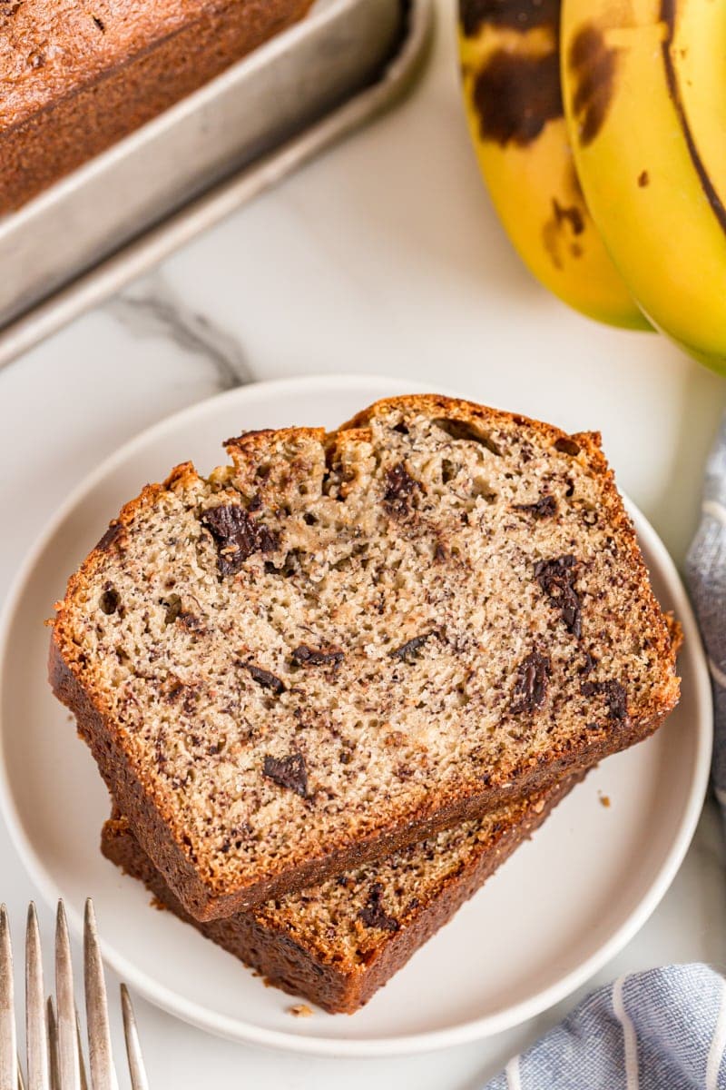 Two slices of Chocolate Chunk Banana Bread stacked on plate