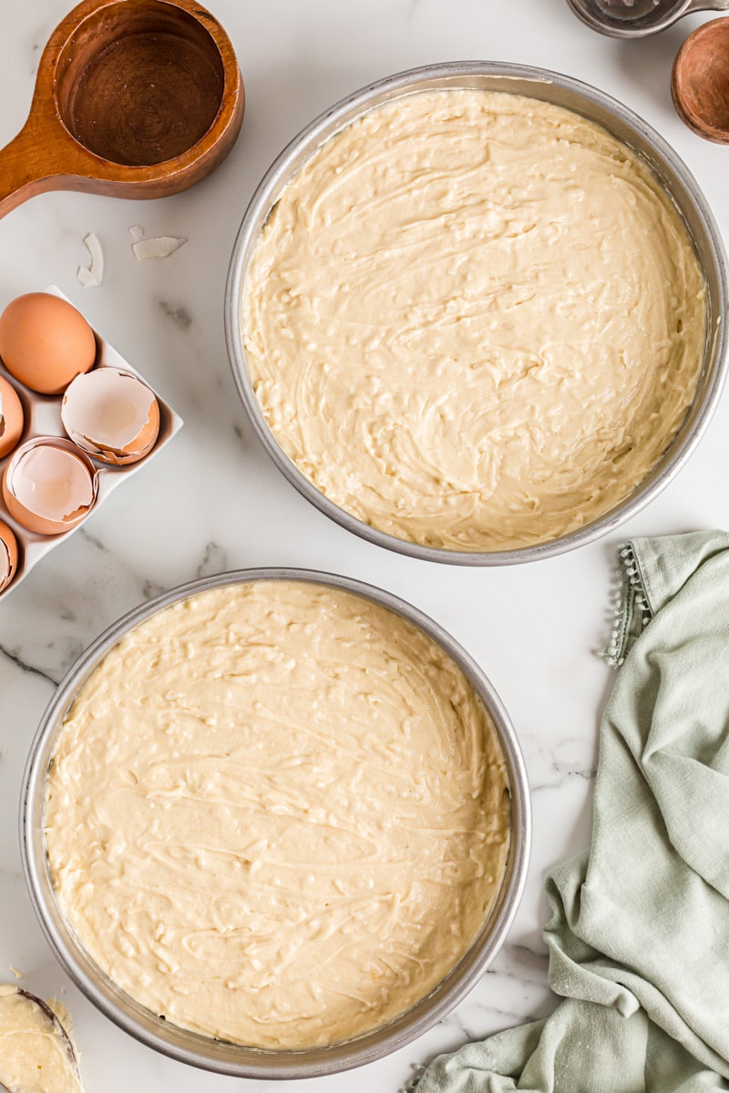 Overhead view of cake batter in 2 round cake pans