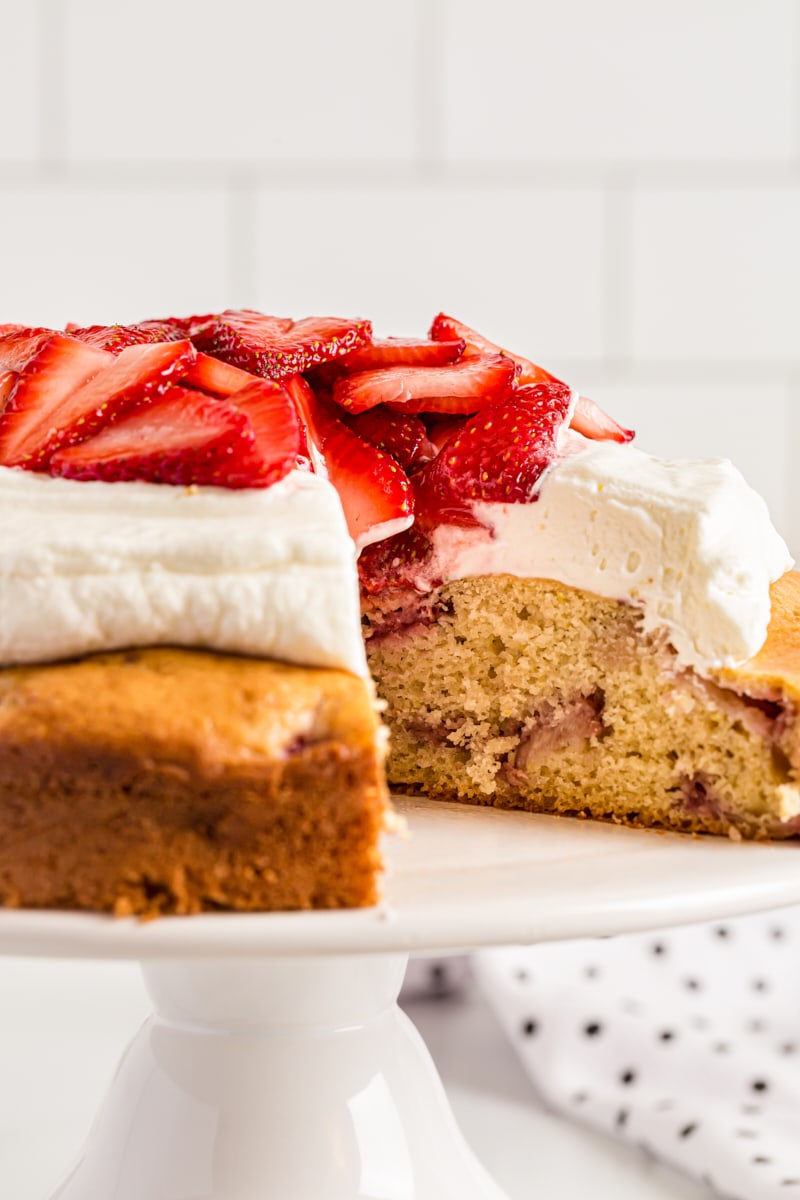 Lemon-Strawberry Shortcake on cake stand with one slice removed