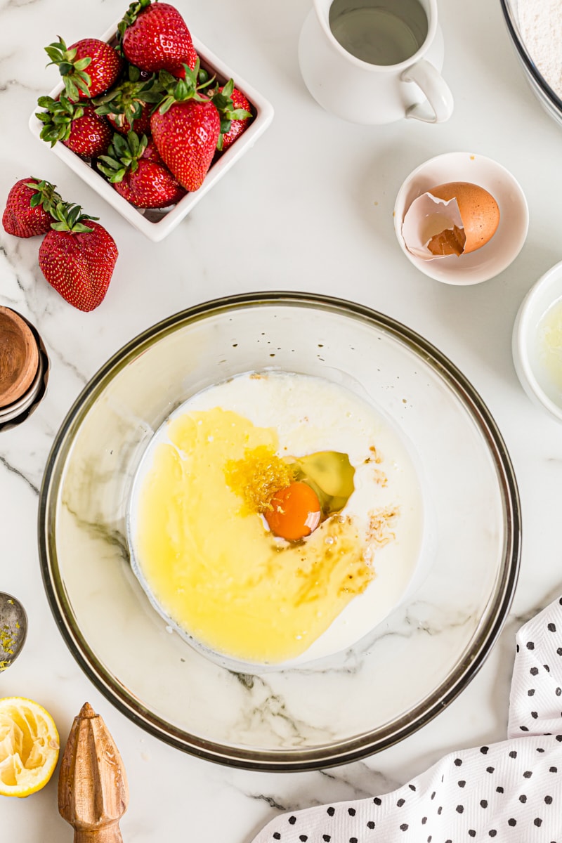 Overhead view of wet ingredients for cake in glass mixing bowl