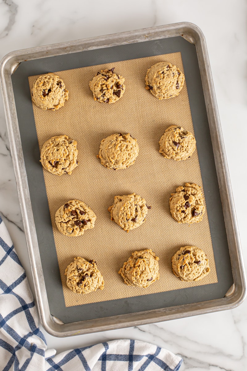 Overhead view of Oatmeal Peanut Butter Chocolate Chip Cookies on silpat-lined baking sheet