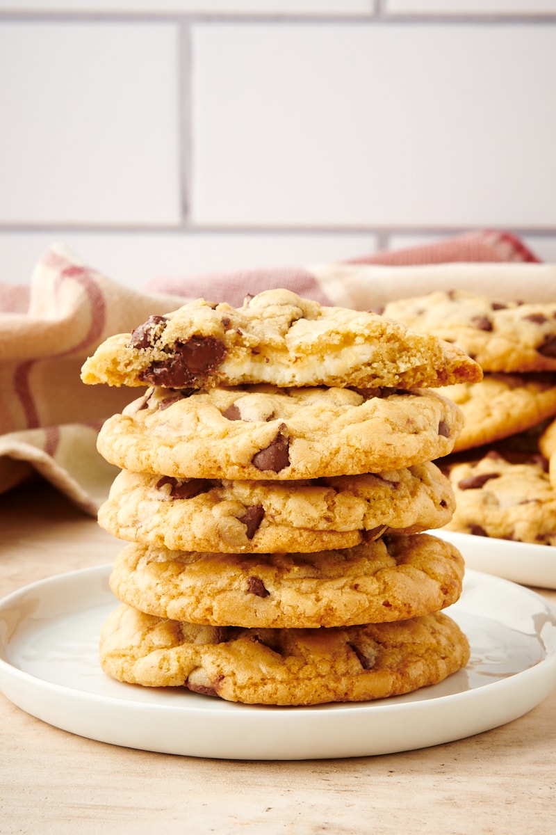 stack of Cheesecake-Stuffed Chocolate Chip Cookies on a white plate