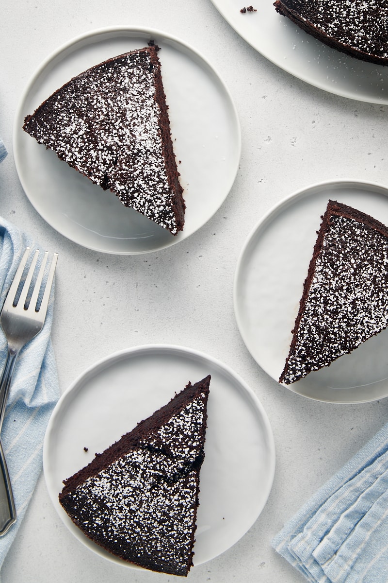 Overhead view of three chocolate cake slices on plates