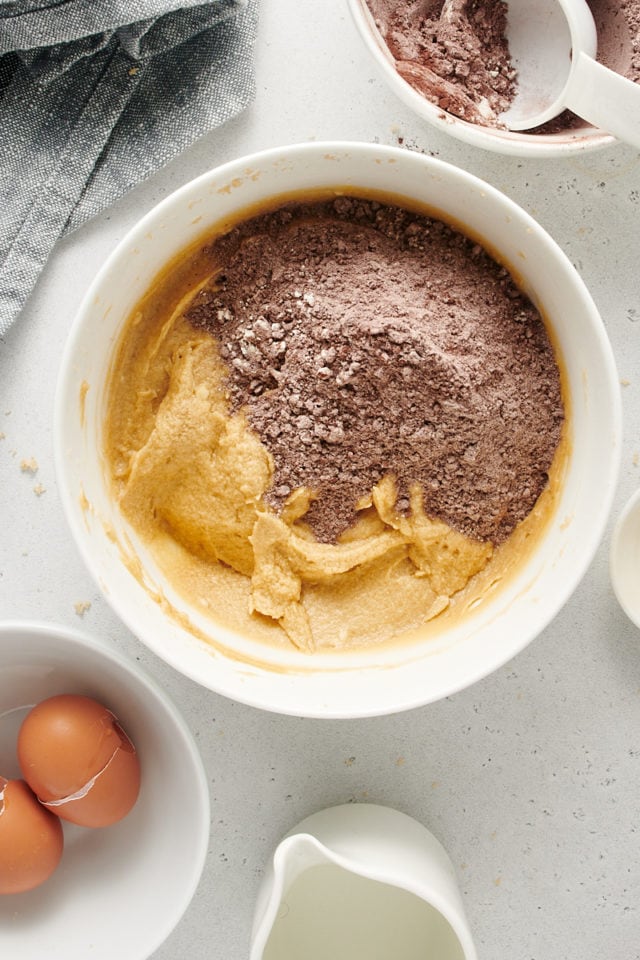 Overhead view of dry and wet cake ingredients in mixing bowl