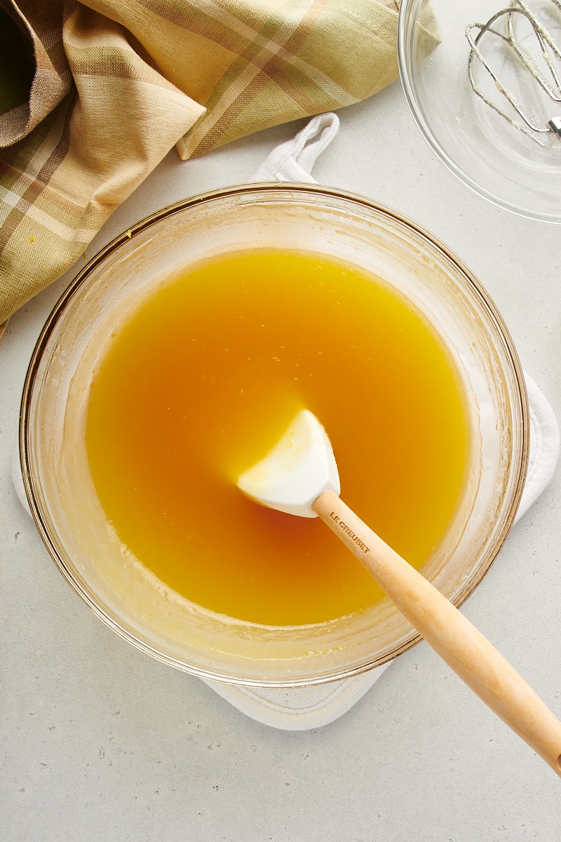 overhead view of cooked lemon curd mixture in a glass mixing bowl