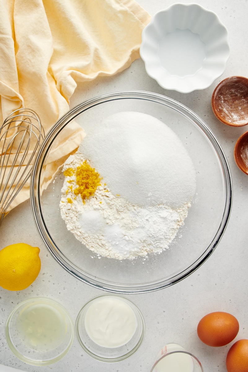 overhead view of dry ingredients and sugar in a glass mixing bowl