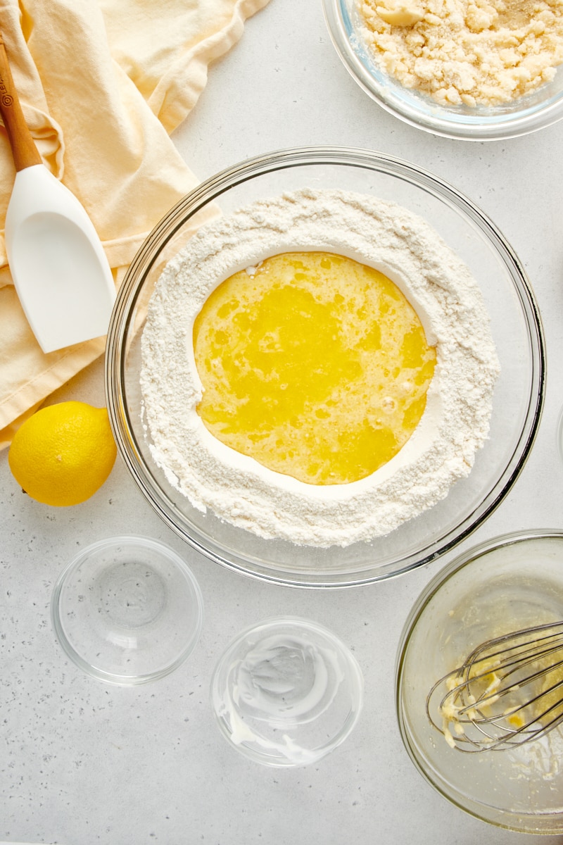 overhead view of wet ingredients added to dry ingredients for Lemon Crumb Muffins