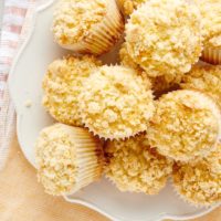 overhead view of Lemon Crumb Muffins piled on a white plate