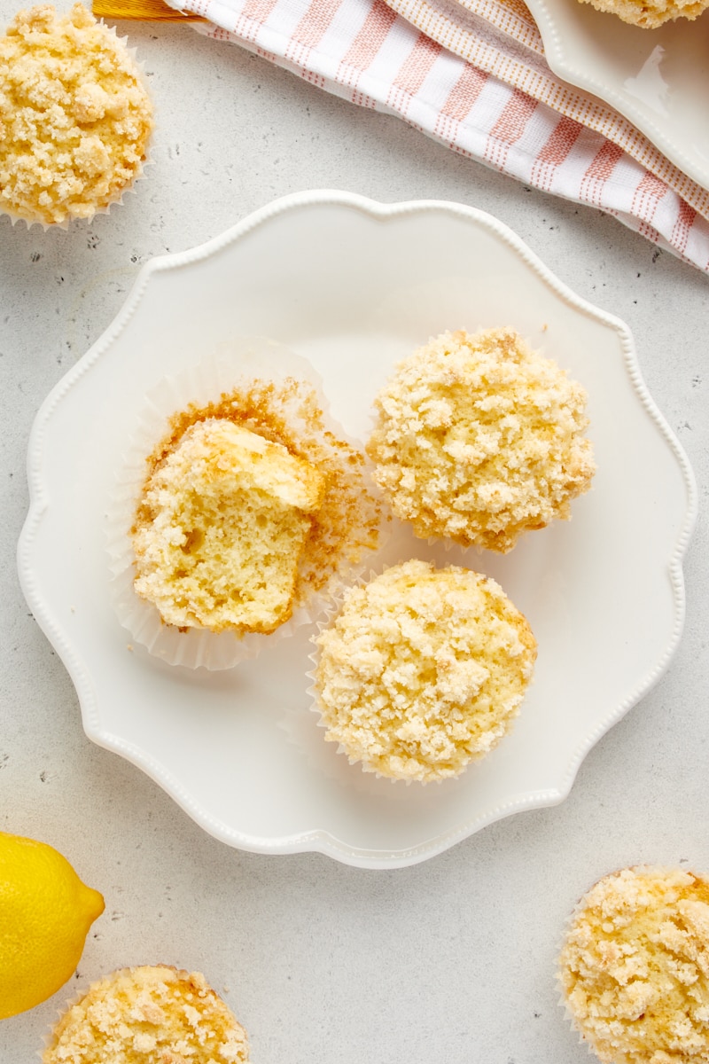 overhead view of three Lemon Crumb Muffins on a white plate