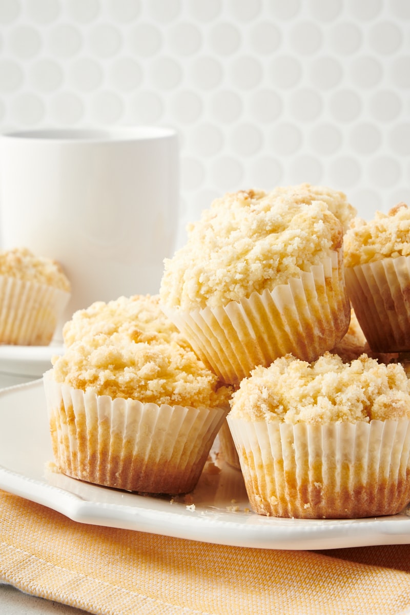 Lemon Crumb Muffins piled on a white plate