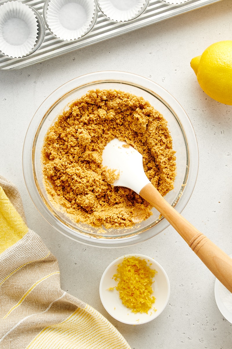 overhead view of graham cracker crumb mixture in a glass mixing bowl