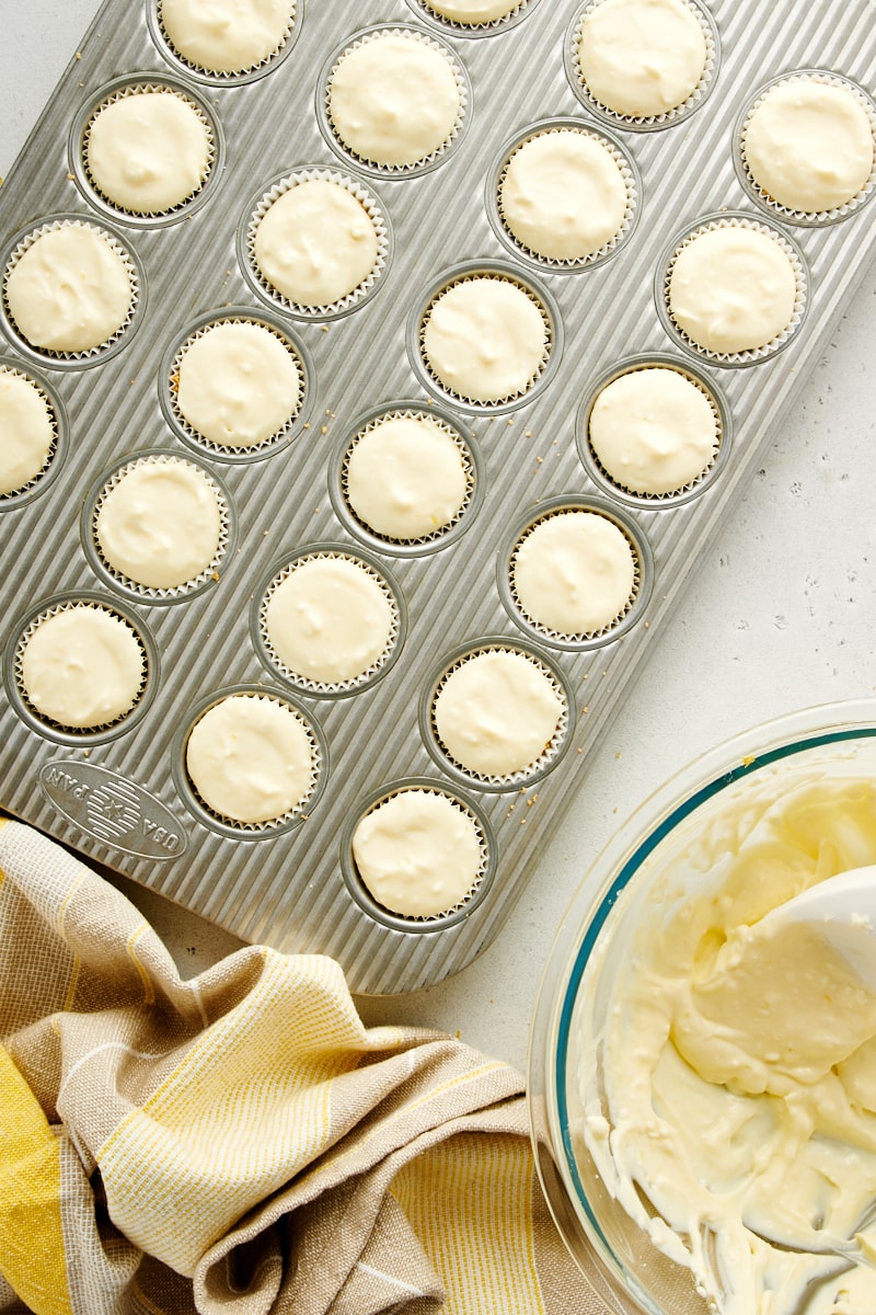 overhead view of portioned Mini Lemon Cheesecakes ready to go into the oven