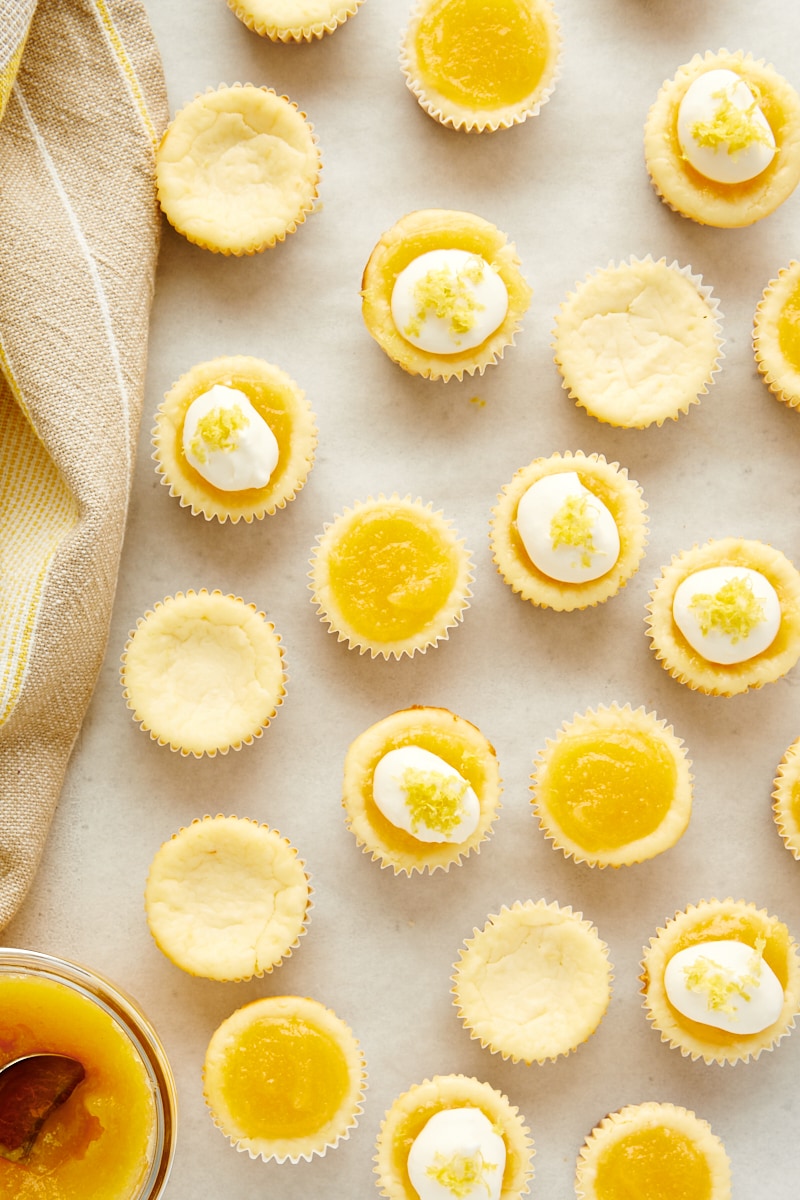 overhead view of Mini Lemon Cheesecakes with various toppings