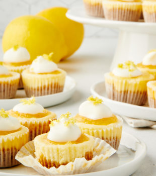 Mini Lemon Cheesecakes on small white plates and a white cake stand