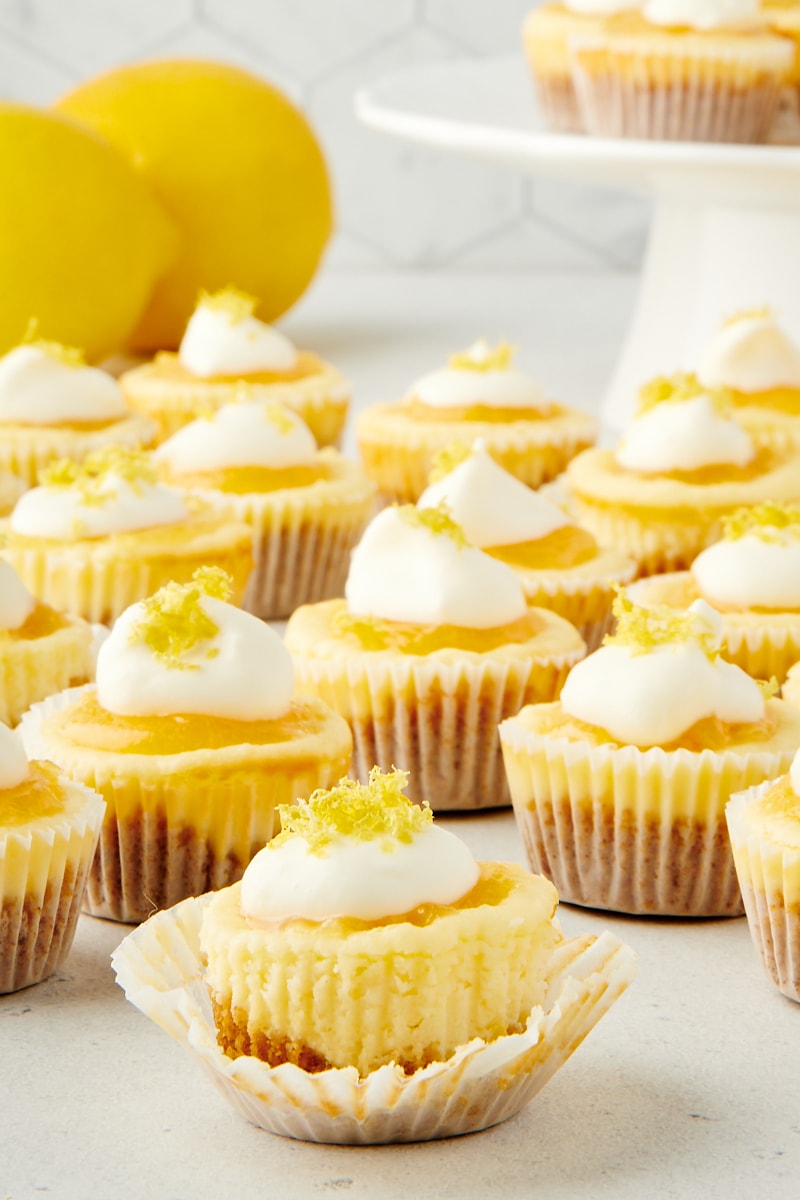 a partially unwrapped Mini Lemon Cheesecake with more cheesecakes surrounding