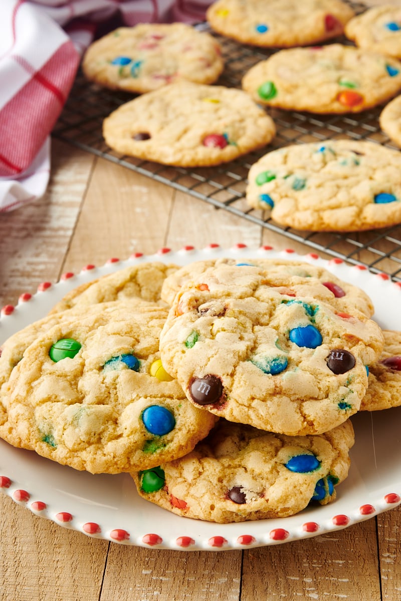 M&M cookies stacked on plate and wire rack