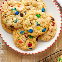 Overhead view of M&M cookies on plate and cooling rack