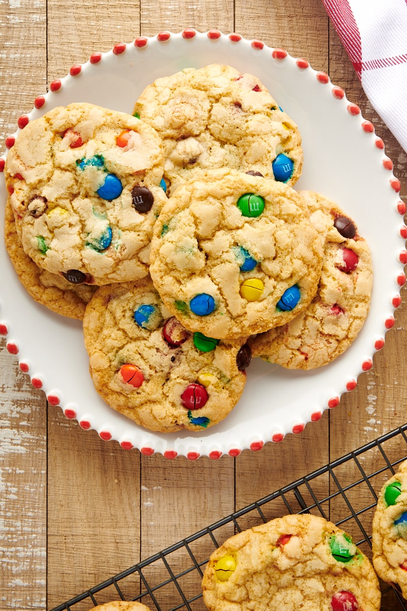 Overhead view of M&M cookies on plate and cooling rack