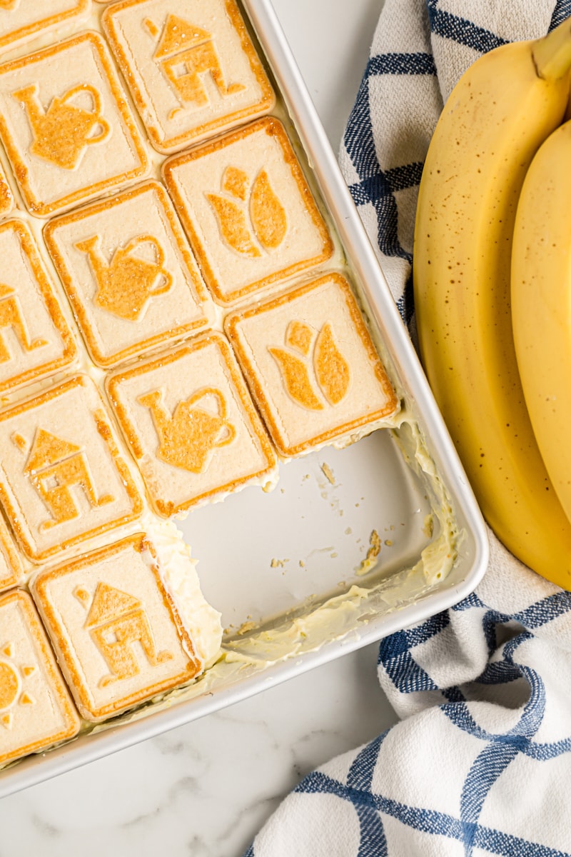 Overhead view of banana pudding in dish with two portions removed