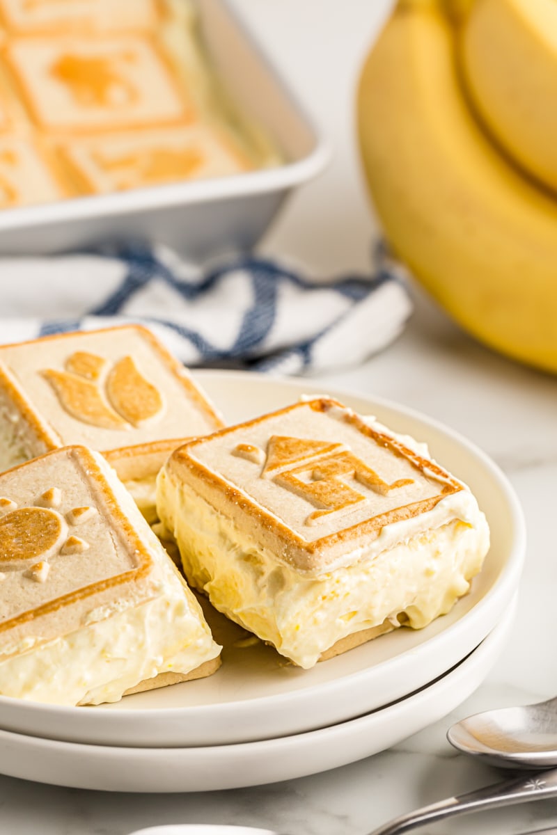 Squares of banana pudding on stacked plates