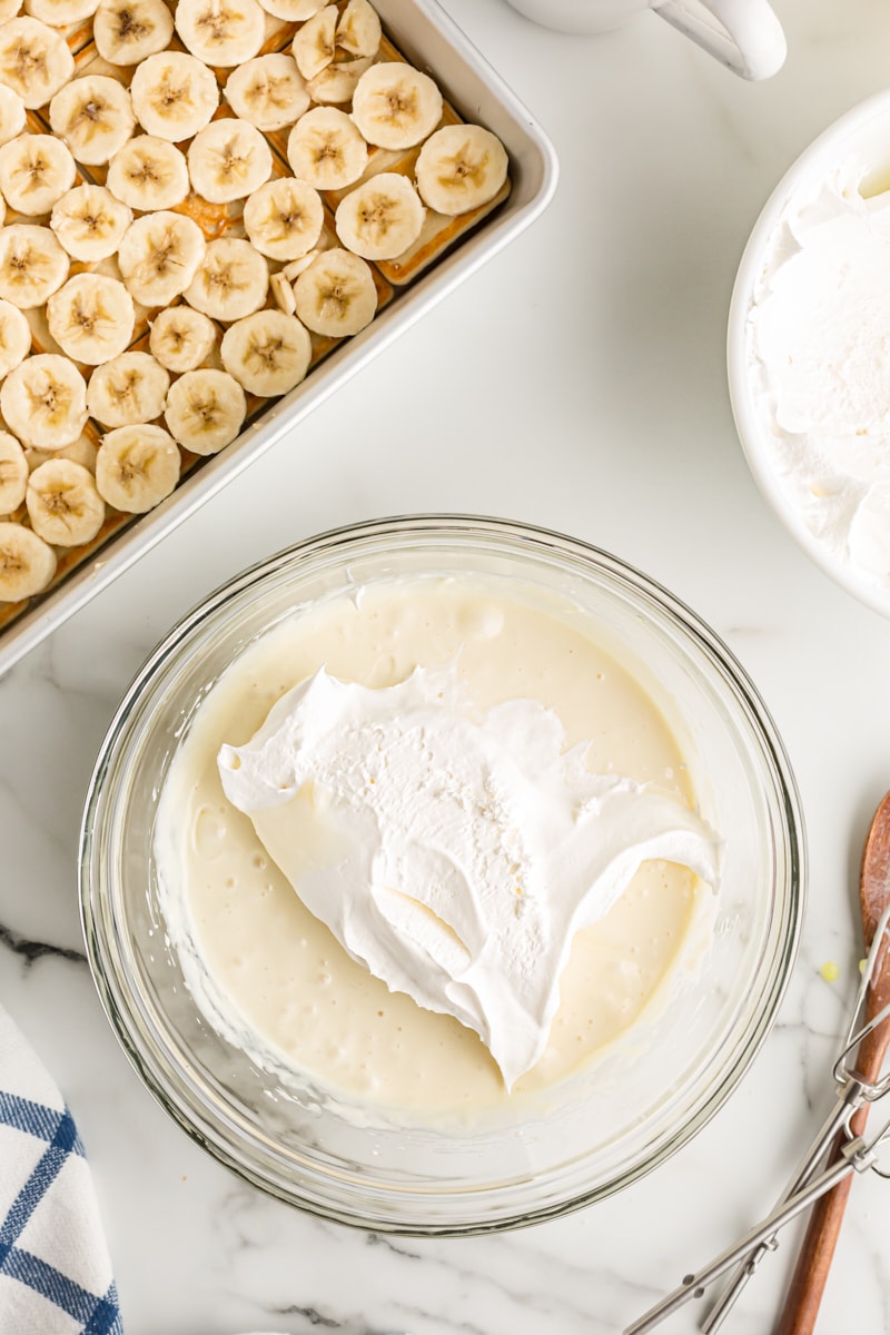 Overhead view of whipped topping added to cream cheese mixture