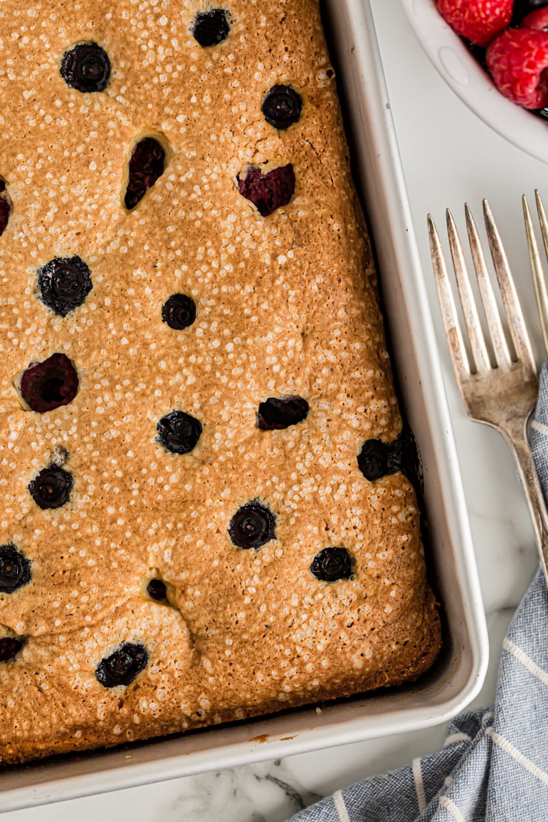 Overhead view of berry vanilla cake in pan