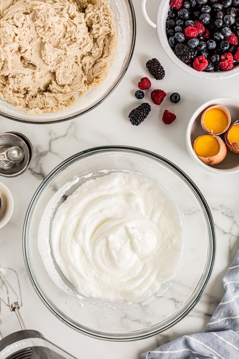 Overhead view of egg whites in glass mixing bowl