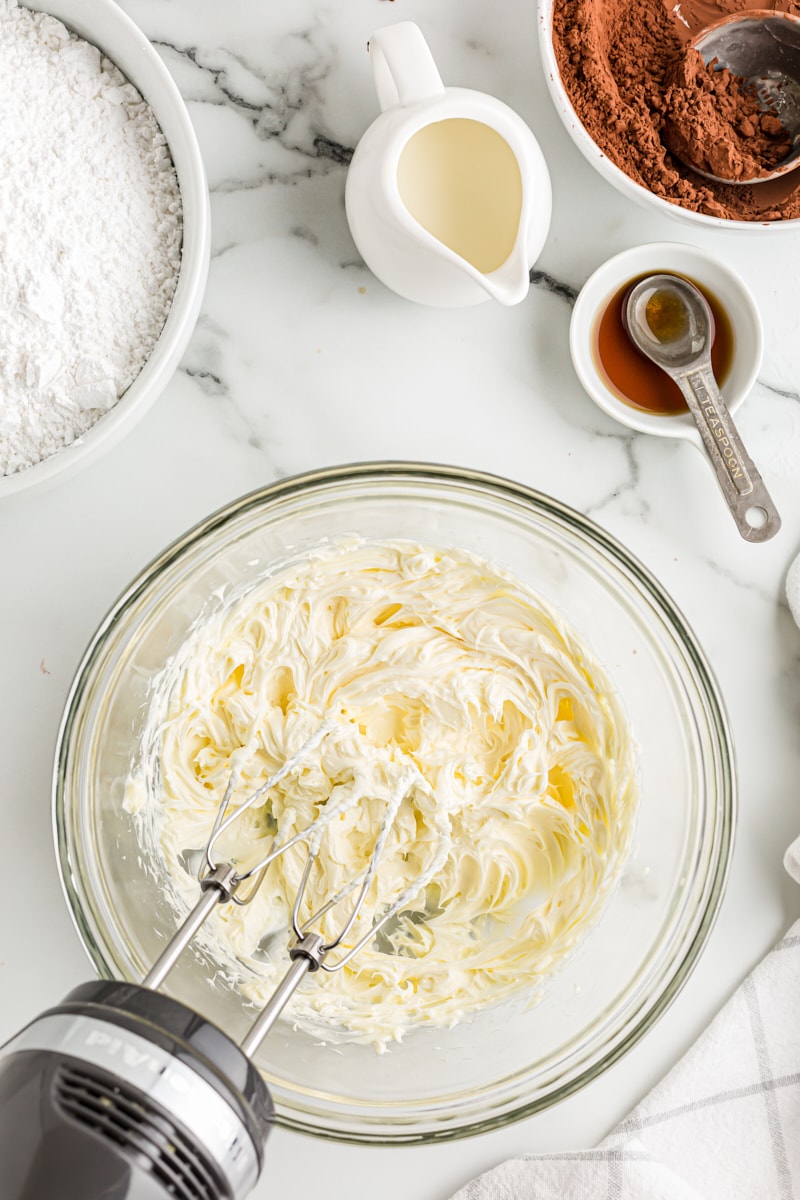 overhead view of creamed butter in a glass mixing bowl