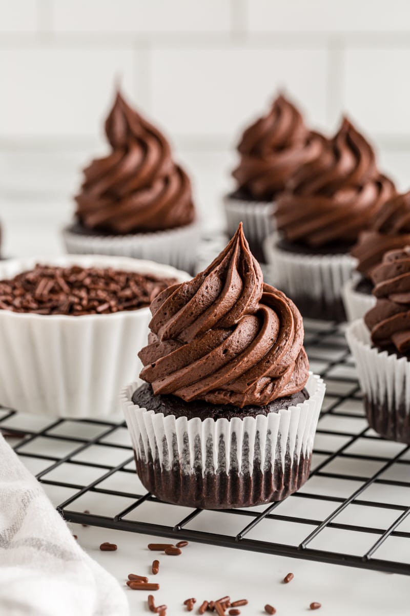 frosted chocolate cupcakes on a wire rack