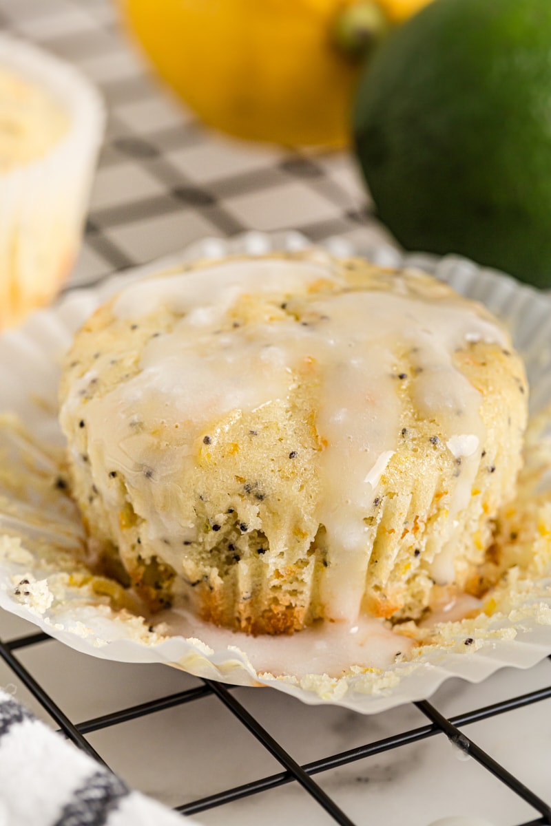 Unwrapped citrus poppy seed muffin with glaze running down sides