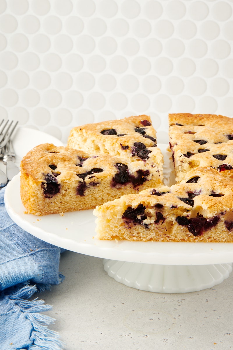 Sliced blueberry cake on cake stand