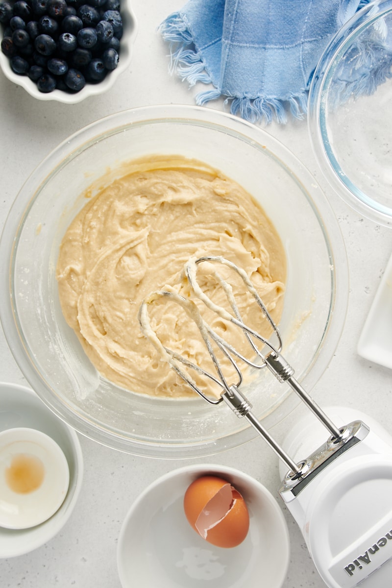 Overhead view of cake batter in mixing bowl with hand mixer
