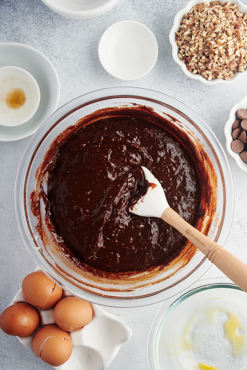 Overhead view of brownie batter in glass mixing bowl