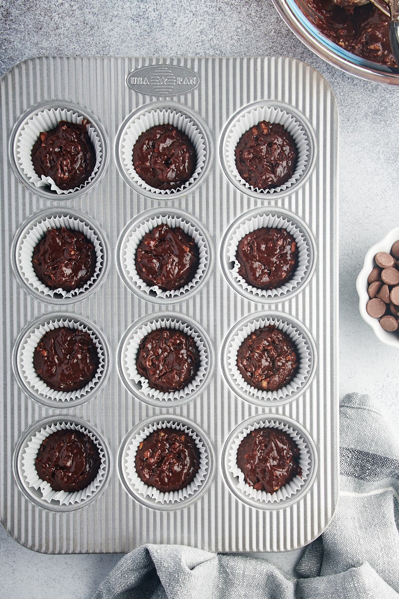 Overhead view of brownie batter in muffin tin