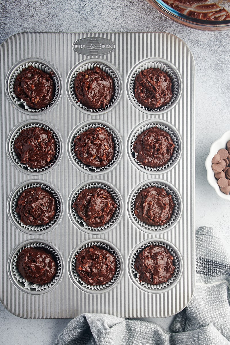 Overhead view of brownie cupcake batter in muffin tin