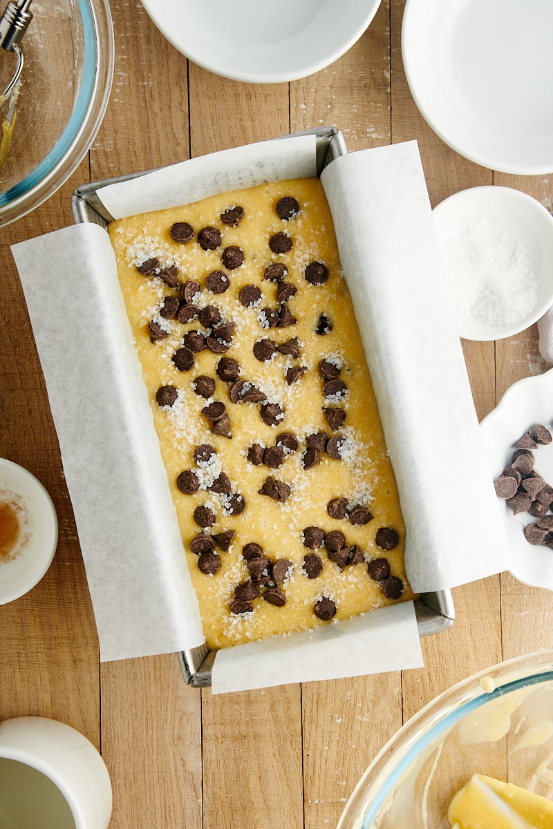 overhead view of Chocolate Chip Loaf Cake batter in a parchment-lined loaf pan