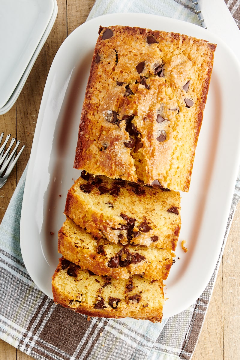 overhead view of sliced Chocolate Chip Loaf Cake on a white serving tray