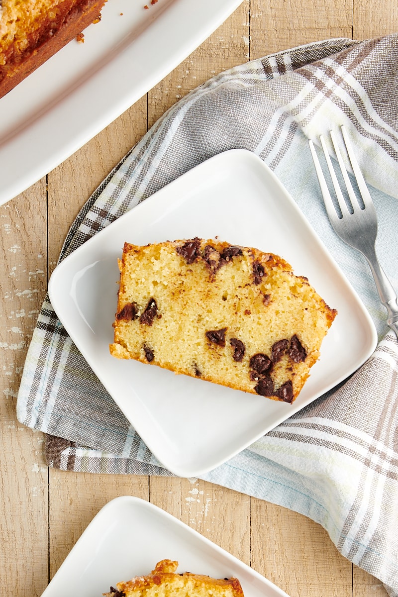 overhead view of a slice of Chocolate Chip Loaf Cake on a square white plate