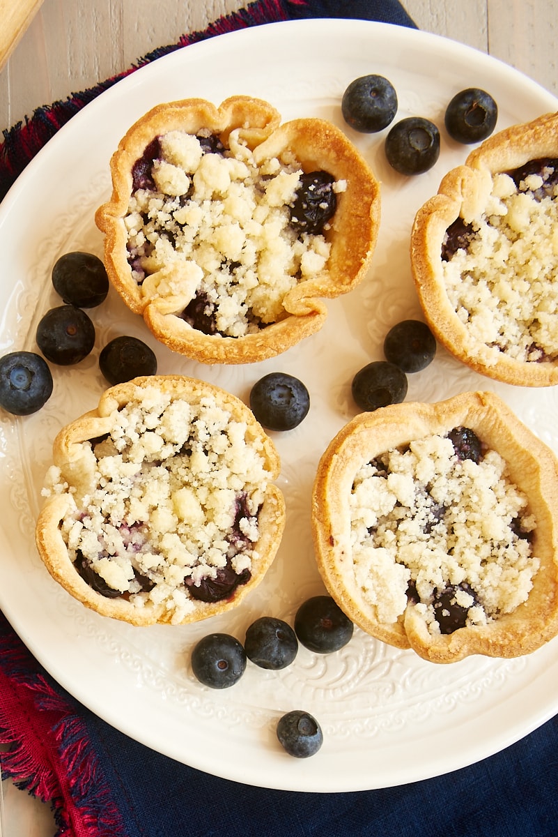 Overhead view of mini blueberry cream cheese pies on plate