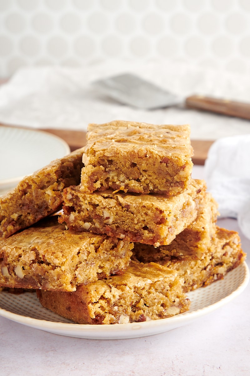 small batch blondies stacked o a white and beige plate