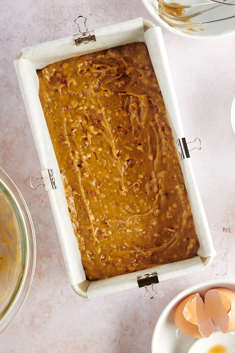 overhead view of blondie batter in a parchment-lined loaf pan