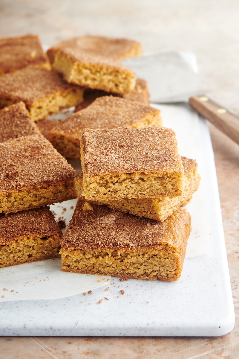 Snickerdoodle bars stacked on white board