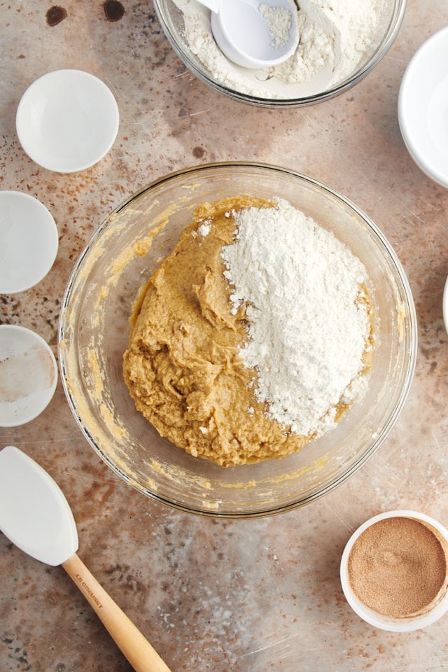 Adding flour to bowl of snickerdoodle bar dough