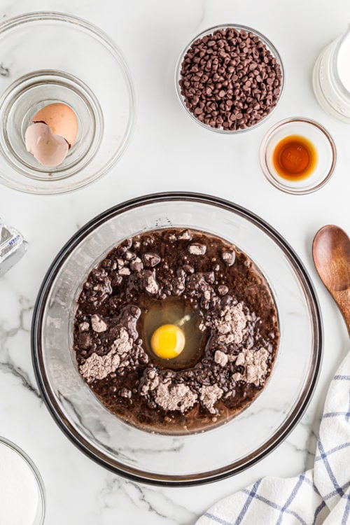Egg cracked into bowl of brownie batter