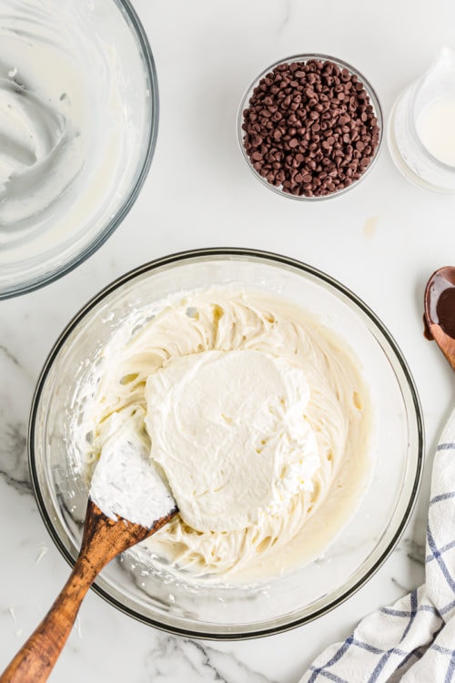 Folding whipped cream into cheesecake batter