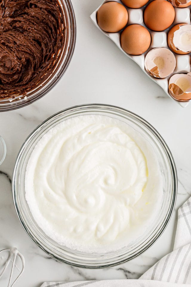 Beaten egg whites in glass bowl