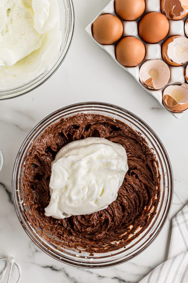 Egg whites added to bowl of chocolate cake batter