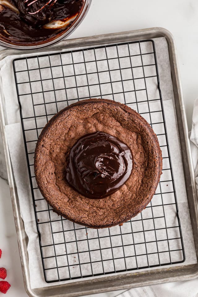 Ganache poured onto flourless chocolate cake