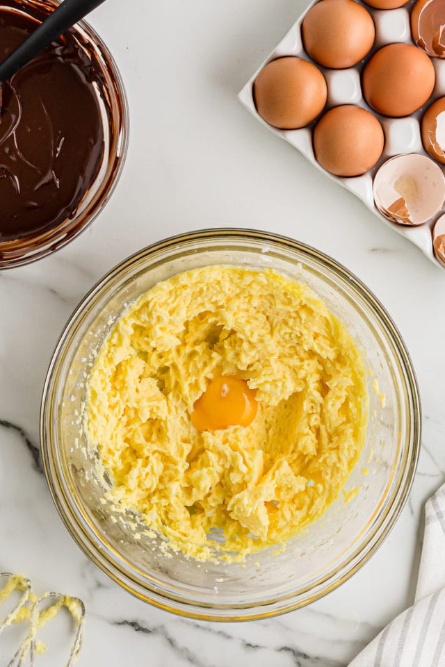 Egg added to other ingredients in mixing bowl